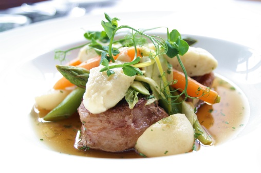 plated lamb dish with seasonal vegetables