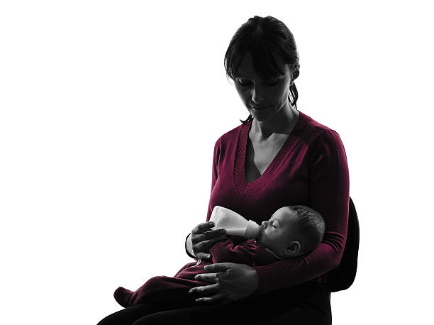 istock woman feeding bottle baby silhouette 459044421
