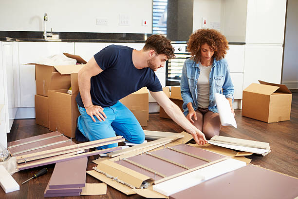 istock Couple assembling furniture in new home 459044699