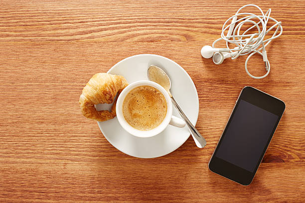 istock Having coffee and croissants with smartphone 459044737
