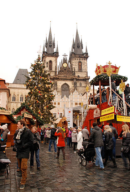 Prague Christmas market Prague,Czech Republic-December 29,2011: Tourists and local people on the Christmas market, on the Old Town Square. The Prague Christmas markets consist of brightly decorated wooden huts selling traditional Czech products from handicrafts and hot food. The atmosphere in Prague in December is simply wonderful! prague christmas market stock pictures, royalty-free photos & images