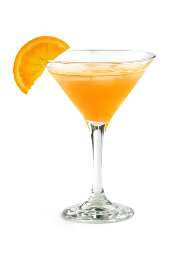 orange cocktail in a martini glass isolated on white background