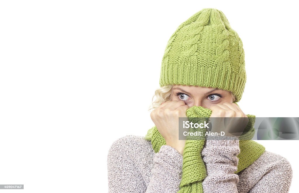 Young woman looking to side Young woman looking to side and wearing wool scarf and cap, isolated on white background. Funny girl Adult Stock Photo