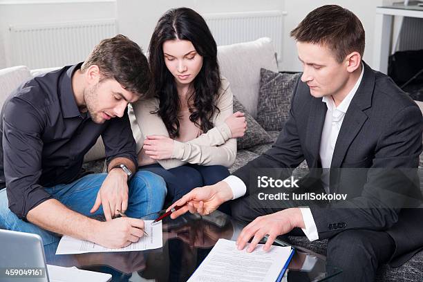 Couple Signing Documents With Agent Stock Photo - Download Image Now - Adult, Advice, Agreement