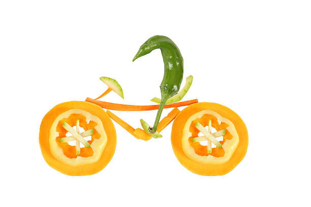 istock Healthy eating. Little funny pepper on bicycle. 459050719