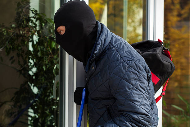 istock Burglar looking inside to house 459058491