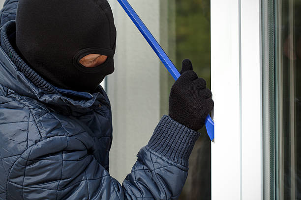istock Housebreaker openning the window 459063449