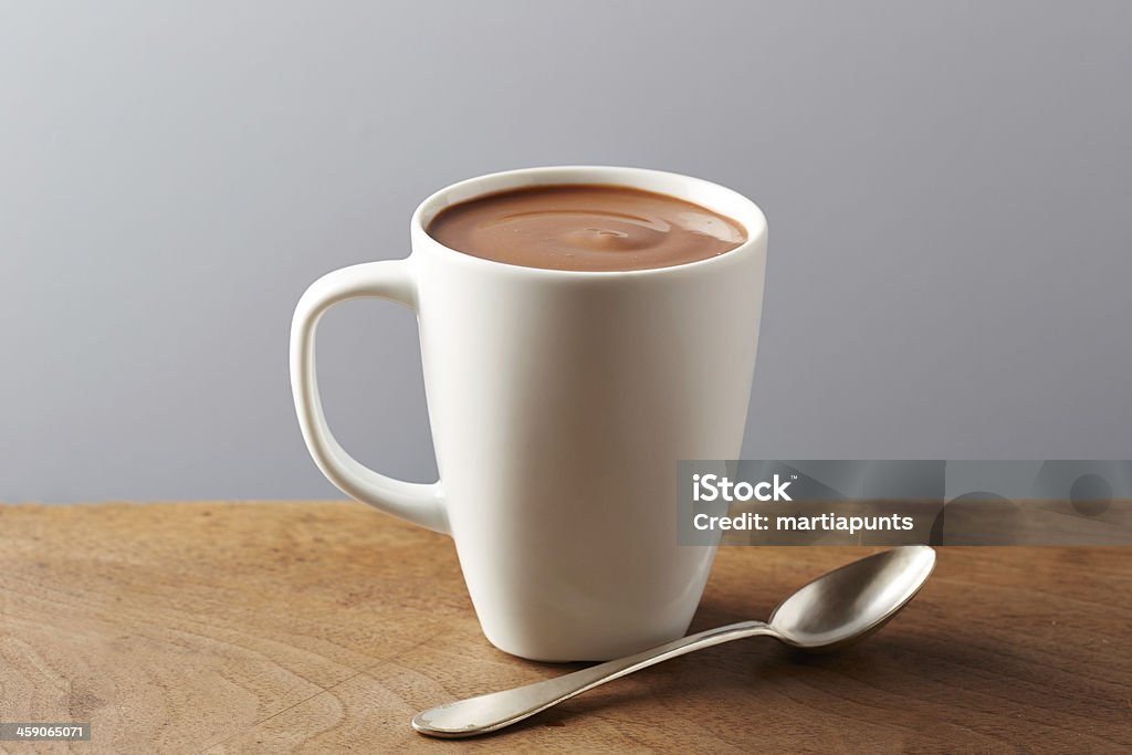 White cup of hot chocolate White cup of hot chocolate on wooden table Hot Chocolate Stock Photo
