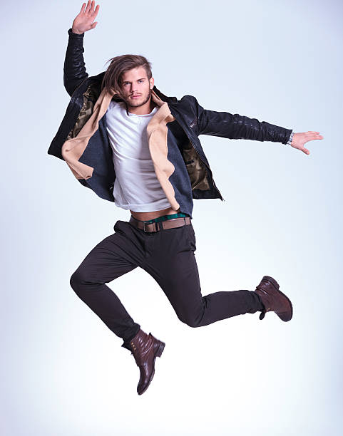 istock young man in casual clothes is making a high jump 459065501