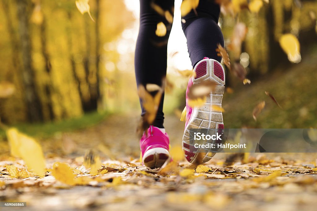 Runner Close up of runner’s feet running in autumn leaves training exercise Autumn Stock Photo