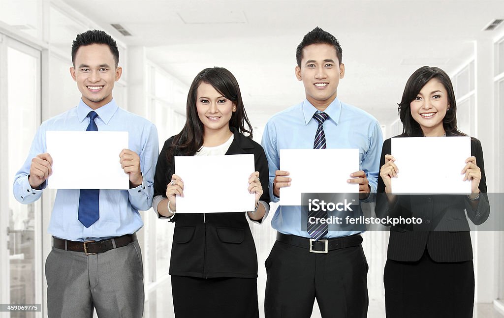 business team holding blank paper business team holding small blank paper in the office Adult Stock Photo