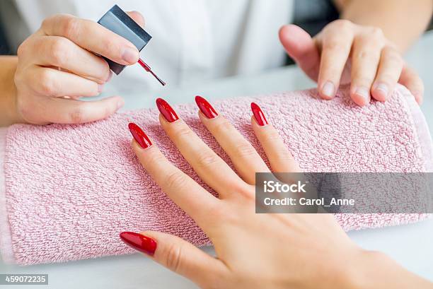 A Woman With Red Painted Nails Getting A Manicure Stock Photo - Download Image Now - Artificial Nail, Fingernail, Painting Fingernails