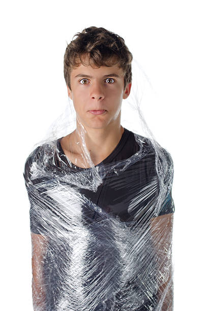 istock Boy wrapped in shrinkwrap cellophane 459081553