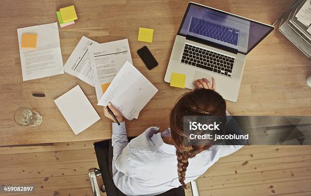 Businesswoman Working At Her Office Desk With Documents And Laptop Stock Photo - Download Image Now