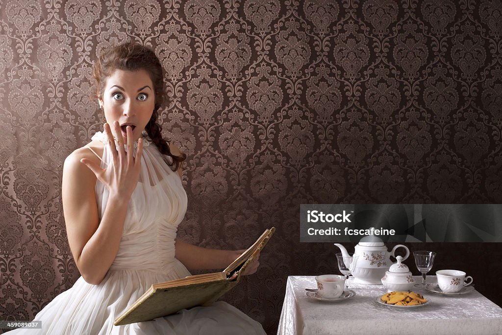 beauty surprise woman read a book in the tea time vintage scene Alice in Wonderland - Fictional Character Stock Photo