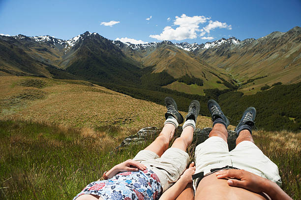 istock Low Section Of Couple Lying In Grass By Mountains 459091441