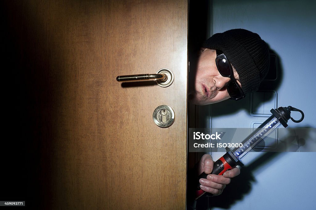 Thief in a house Thief entering a house Adult Stock Photo