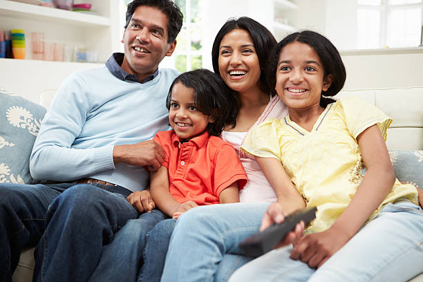 istock Indian Family Sitting On Sofa Watching TV Together 459093815