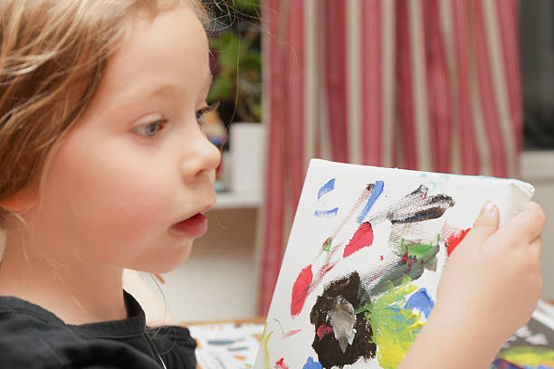 istock Young girl painting 459094695
