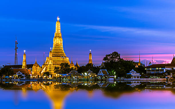 Picturesque skyline of Wat Arun with lit-up buildings stock photo