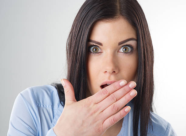 istock woman with hand over mouth 459106383