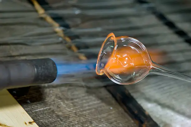 Closeup of a flame and melting glass piece