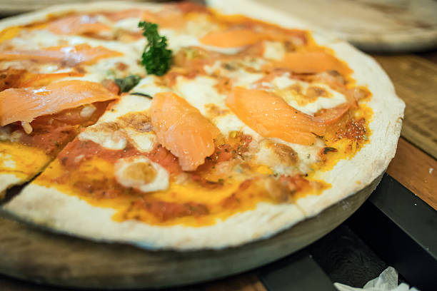 istock Smoked salmon pizza produces from wood fired oven. 459109775