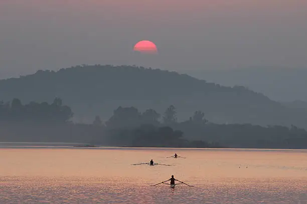 Sun rise view at Sukhna lake chandigarh, India.  India is an artificial lake at the foothills of the Himalayas, the Shivalik hills. Sukhna Lake serves as a great picnic spot and an apt place for pursuing water sport activities like boating, yachting and water skiing etc