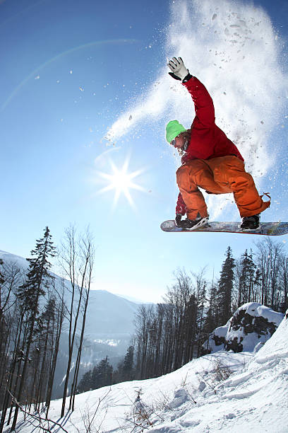 istock Snowboarder airborne jumping into snowy forest 459117109