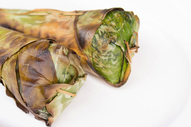 Sticky rice roast , wrapped in banana leaves and white backgroun stock photo