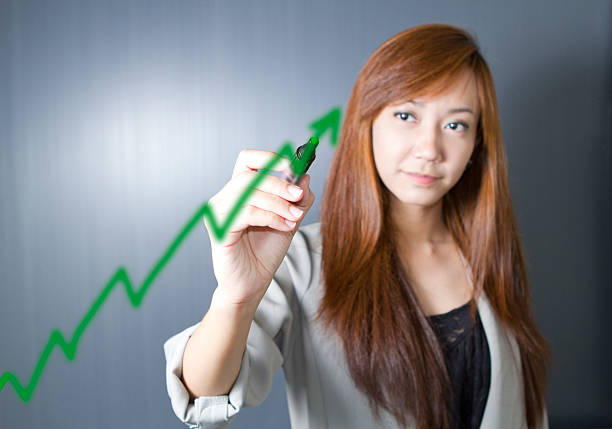 istock Women draw success diagram. 459119219
