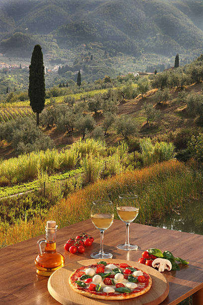 istock Italian pizza with white wine outdoors in Chianti Italy 459120253