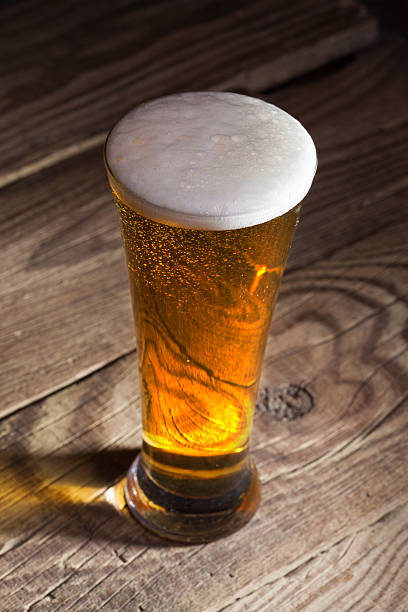 istock Mug of beer on wooden background 459121315