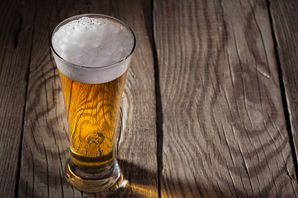 istock Mug of beer on wooden background 459121335