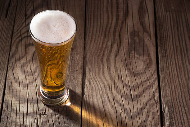 istock Mug of beer on wooden background 459121365
