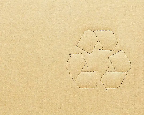 Photo of Recycling symbol on tan cardboard box