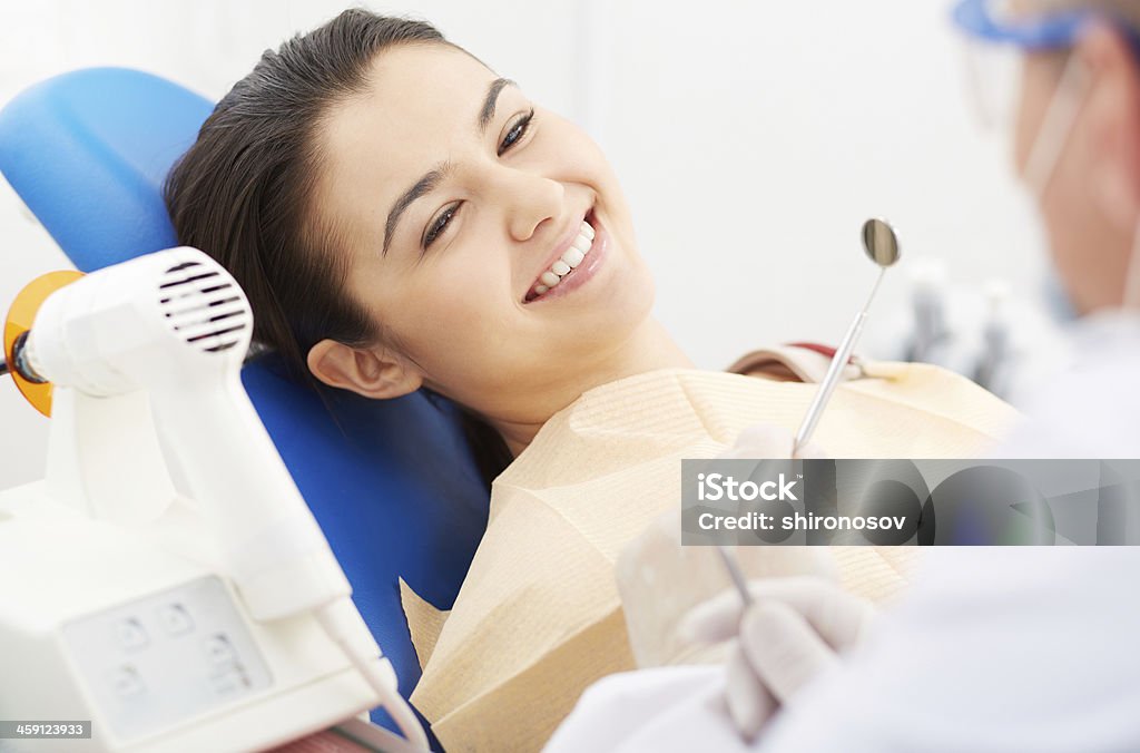 Happy patient Image of smiling patient looking at the dentist Adult Stock Photo