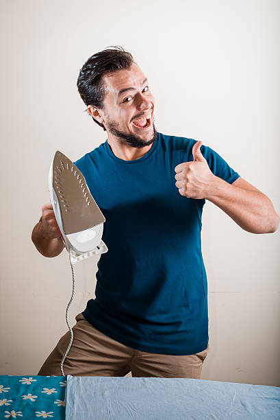 istock young stylish man housewife ironing 459129363