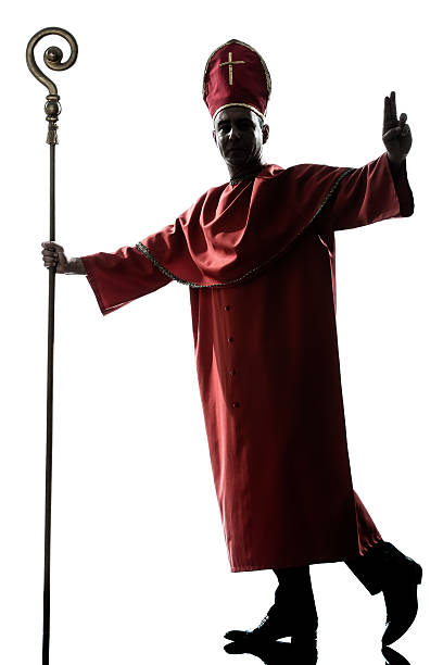 istock man cardinal bishop silhouette saluting blessing 459136017