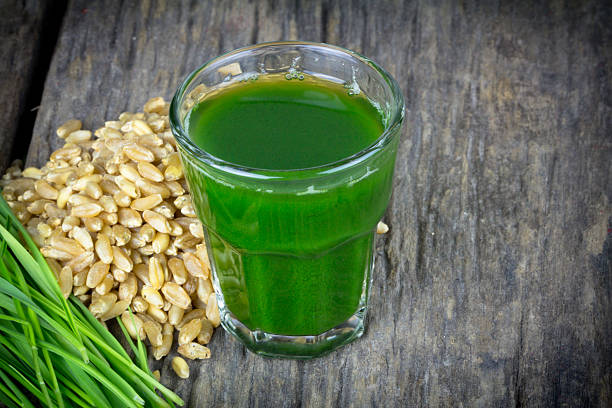 istock Wheat grass juice on wood background 459136893