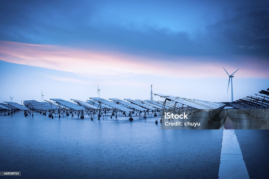 solar and wind power in bad weather solar and wind power in bad weather,green energy background. Solar Power Station Stock Photo