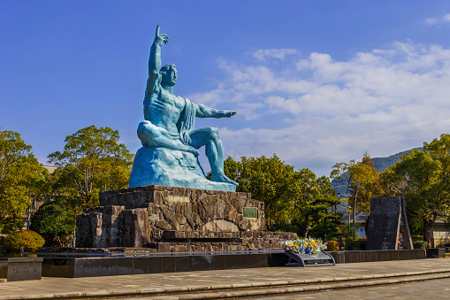Nagasaki, Japan - November 14 2013: Nagasaki peace statue, the statue's right hand points to the thret of nuclear while the extended left hand symbolizes eternal peace