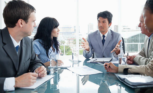 istock Young businessman seriously communicating with his team 459151365
