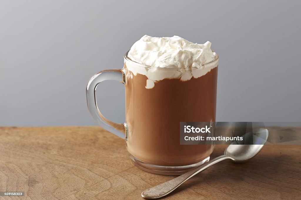 Cup of hot chocolate with whipped cream Cup of hot chocolate with whipped cream on wooden table Backgrounds Stock Photo