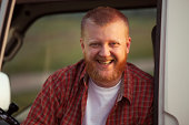 Cheerful red-bearded man in a plaid shirt