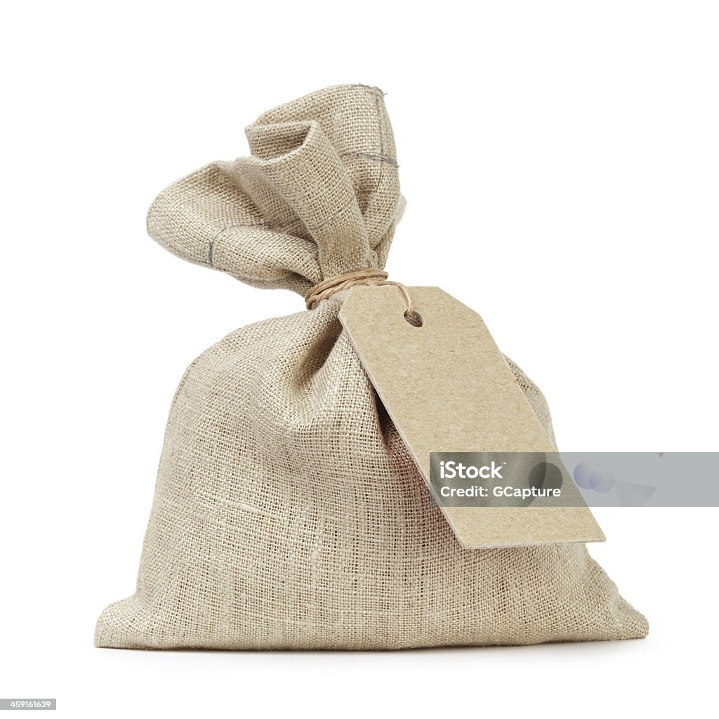 A tied up sack type of bag with a white paper tag tied sack bag with paper tag, isolated on white Sack Stock Photo