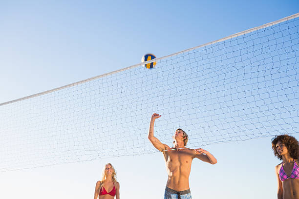 istock Young friends playing beach volleyball together 459164853