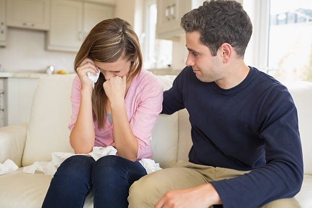 istock Woman sitting crying on the sofa with her husband 459164861