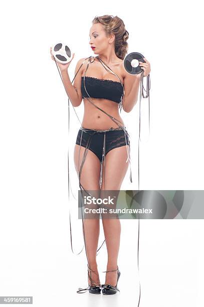 Attractive Woman With An Audio Retro Bobbins Stock Photo - Download Image Now - Adult, Adults Only, Audio Equipment