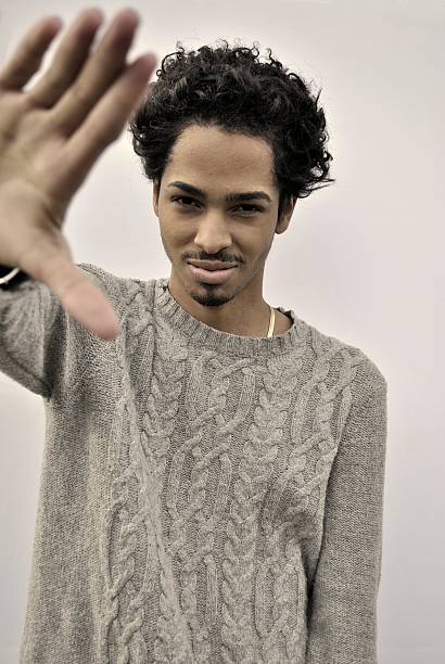 istock young black man with hand stretched out 459189473